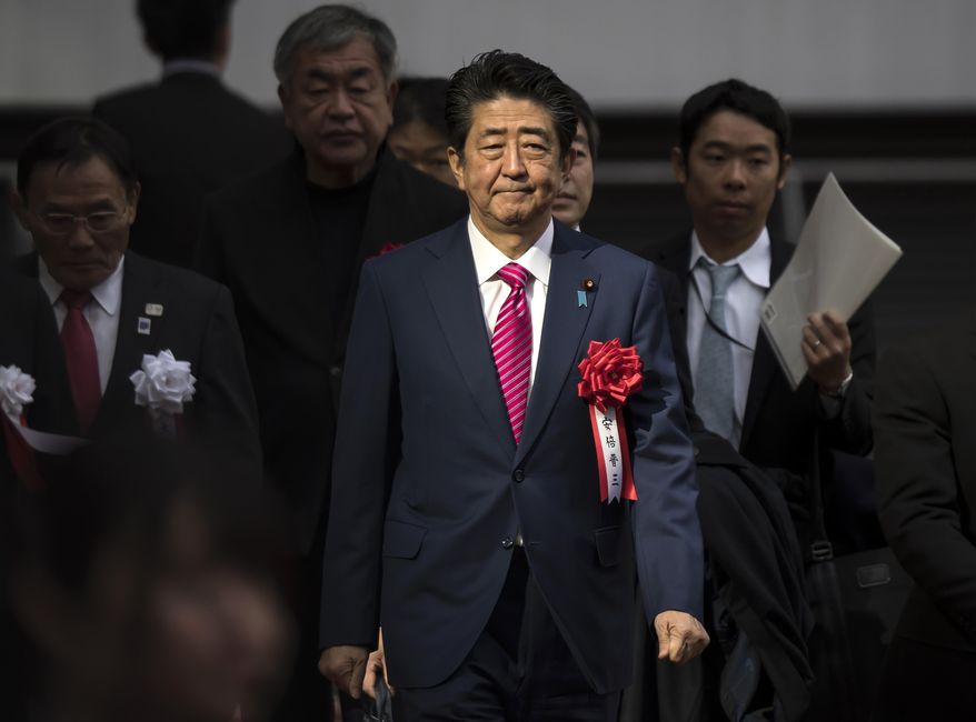 FILE - In this Dec. 15, 2019, file photo, Japan&#39;s Prime Minister Shinzo Abe arrives for the construction completion ceremony of the New National Stadium, the venue for next year&#39;s opening and closing ceremony of the Tokyo Olympics and track and field in Tokyo, Japan. In a meeting Monday, Feb. 3, 2020, with the national legislature, Abe reassured them that the Summer Olympics will be taking place on schedule despite rumors of it being affected by the current coronavirus outbreak. (Tomohiro Ohsumi/Pool Photo via AP)