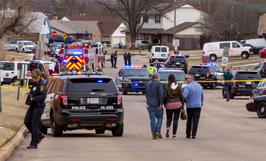 Emergency crews respond to a scene where a vehicle hit several Moore High School students, killing at least one, in Moore, Okla., Monday, Feb. 3, 2020. At least one girl was killed and several other people were injured, three critically, when a motorist slammed his vehicle into the high school cross-country team as they ran along a street outside their suburban Oklahoma City school Monday, officials said. (Chris Landsberger/The Oklahoman via AP)