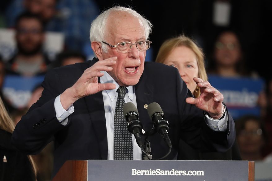 Democratic presidential candidate Sen. Bernie Sanders, I-Vt., with his wife Jane O&#39;Meara Sanders, speaks to supporters at a caucus night campaign rally in Des Moines, Iowa, Monday, Feb. 3, 2020. (AP Photo/Pablo Martinez Monsivais)