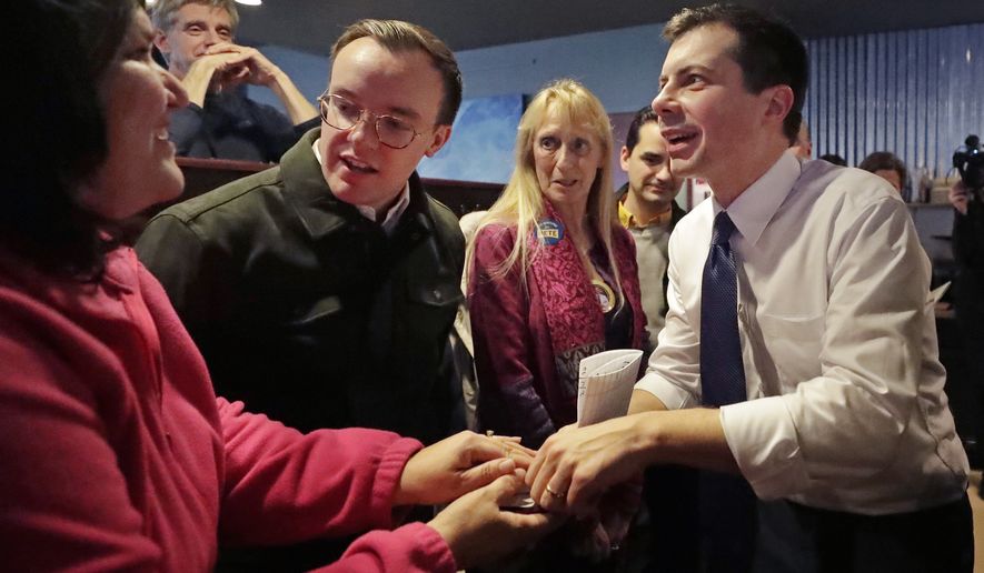 Democratic presidential candidate former South Bend Mayor Pete Buttigieg, right, and his husband, Chasten Buttigieg, left, greet people at a campaign event, Tuesday, Feb. 4, 2020, in Hampton, N.H. (AP Photo/Elise Amendola)