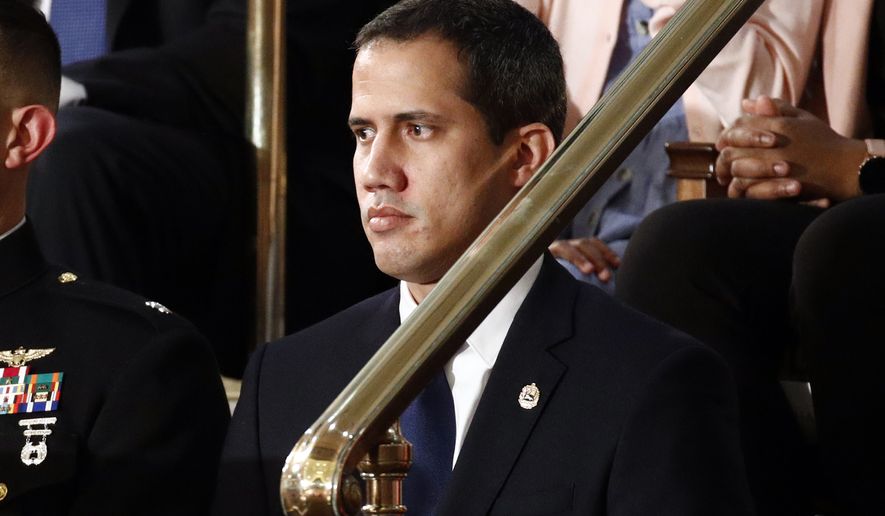 Venezuelan opposition leader Juan Guaido listens as President Donald Trump delivers his State of the Union address to a joint session of Congress on Capitol Hill in Washington, Tuesday, Feb. 4, 2020. (AP Photo/Patrick Semansky)