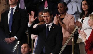 Venezuelan opposition leader Juan Guaido waves as President Donald Trump delivers his State of the Union address to a joint session of Congress on Capitol Hill in Washington, Tuesday, Feb. 4, 2020. (Leah Millis/Pool via AP)