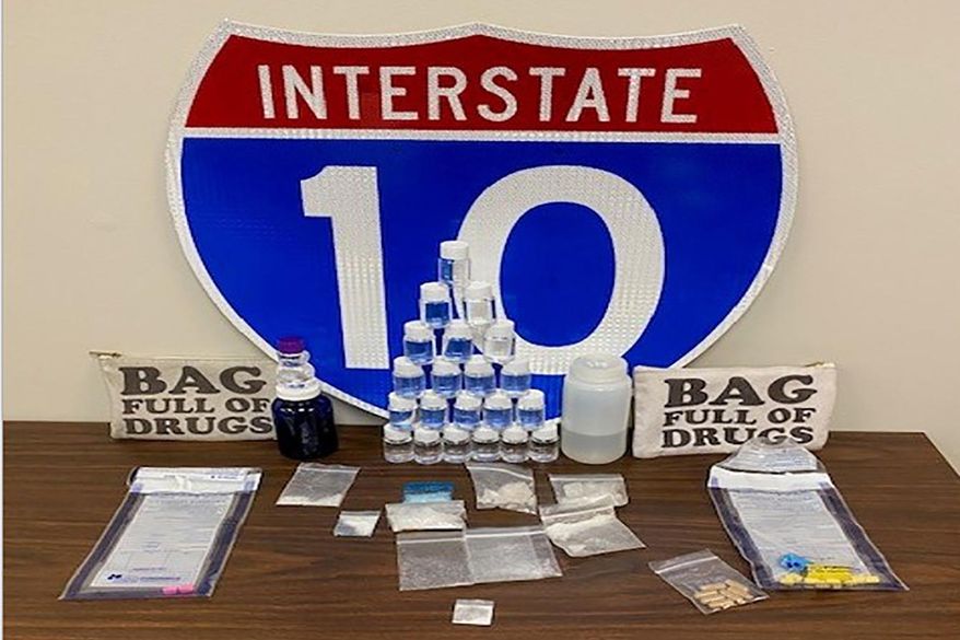 In this photo made available by the Florida Highway patrol shows confiscated drugs following the arrest of two men Tuesday, Feb. 4, 2020, Santa Rosa County, Fla. Authorities confiscated methamphetamine, cocaine and fentanyl. (Florida Highway Patrol via AP)