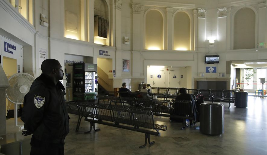 Security guard Damoi Shilon, left, watches over the Greyhound bus terminal on Tuesday, Feb. 4, 2020, in Oakland, Calif. A shooting on a Greyhound bus in California this week illustrates a stark reality about security on other modes of mass transportation in the U.S., those determined to carry out an attack on a bus, train and subway would likely face few if any security checks from any time before or after they take their seats. (AP Photo/Ben Margot)