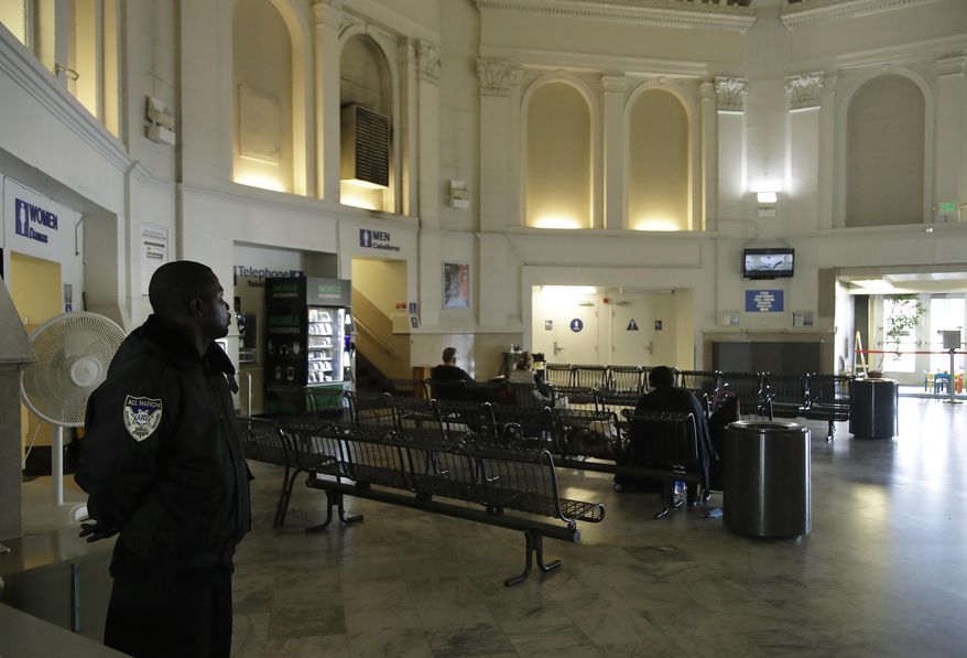 Security guard Damoi Shilon, left, watches over the Greyhound bus terminal on Tuesday, Feb. 4, 2020, in Oakland, Calif. A shooting on a Greyhound bus in California this week illustrates a stark reality about security on other modes of mass transportation in the U.S., those determined to carry out an attack on a bus, train and subway would likely face few if any security checks from any time before or after they take their seats. (AP Photo/Ben Margot)