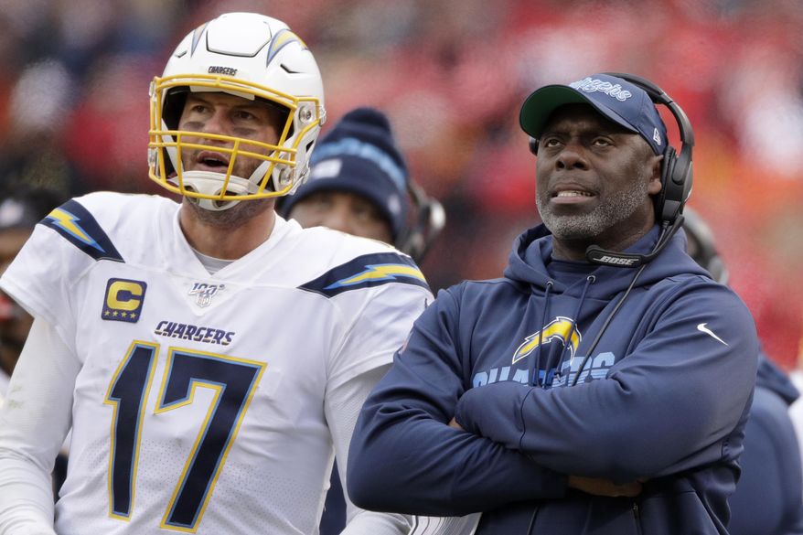 FILE - In this Sunday, Dec. 29, 2019 file photo, Los Angeles Chargers head coach Anthony Lynn stands next to quarterback Philip Rivers (17) during the second half of an NFL football game against the Kansas City Chiefs in Kansas City, Mo. Anthony Lynn will go into next season with a contract extension and a reworked coaching staff. The Los Angeles Chargers coach has signed an extension according to a team official, Tuesday, Feb. 4, 2020. (AP Photo/Charlie Riedel, File)