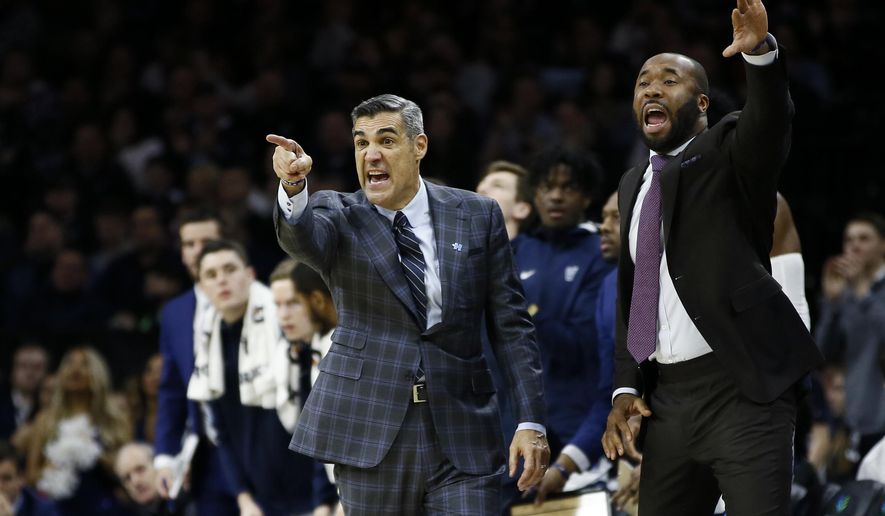 Villanova head coach Jay Wright, left, and assistant coach Kyle Neptune yell to their team during the second half of an NCAA college basketball game against Creighton, Saturday, Feb. 1, 2020, in Philadelphia. (AP Photo/Matt Slocum)