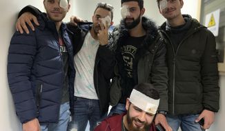 In this Jan. 27, 2020 photo, anti-government protesters, who were injured during clashing with riot police, pose for a group picture after a check up with an ophthalmologist at a hospital in Beirut, Lebanon. The five pledged that they’ll be back in the streets soon. Such resolve signals that demands for sweeping government reforms won’t be squashed easily, even as security forces resort to more violent means of crowd control, such as rubber bullets. (AP Photo/A.J. Naddaff)