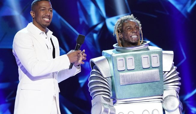 This image released by Fox shows host Nick Cannon, left, with Lil Wayne in the third season premiere of &amp;quot;The Masked Singer,&amp;quot; which aired on Sunday after the Super Bowl. The special edition of the show, with Lil&#x27; Wayne as the mystery guest, had its biggest audience ever Sunday when 23.7 million people watched it, the Nielsen company said. (Greg Gayne/FOX via AP)  **FILE**
