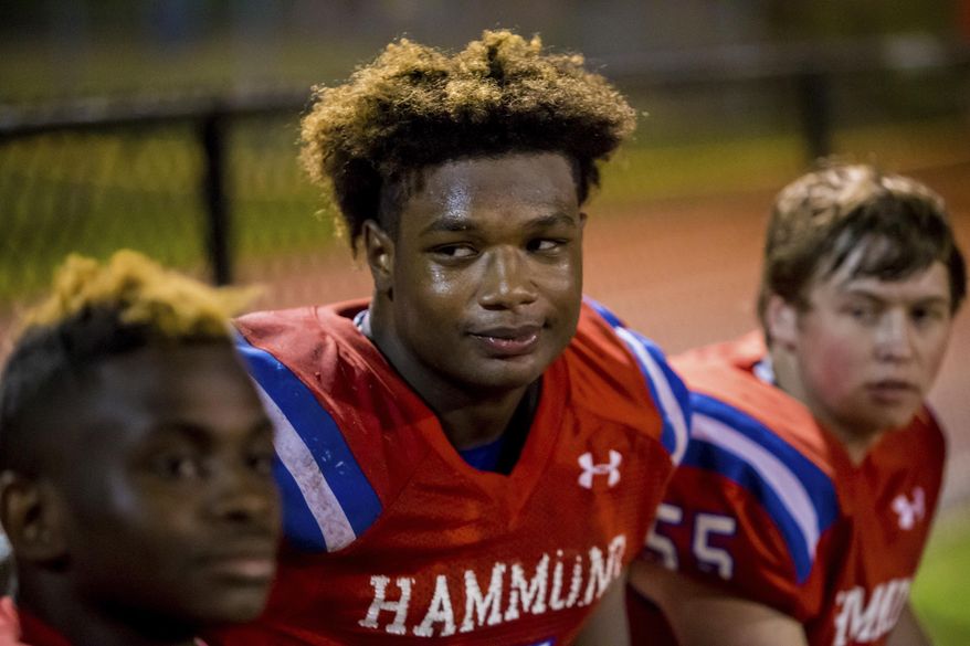 In this Nov. 2, 2018 photo, Hammond Skyhawks Jordan Burch (5) watches during the a high school football playoff game against Wilson Hall in Columbia, S.C. The-6-foot-5, 275-pound Burch is a potential immediate-impact player out for the Gamecocks. When the early signing period opened in December he announced he would stay close to home. But he didn't actually sign, leaving open the possibility LSU could be his final destination. (Jeff Blake/The State via AP)