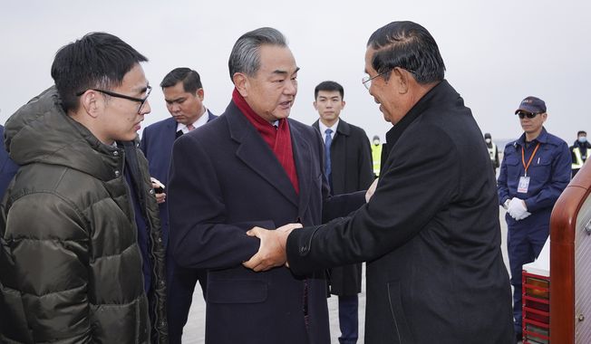 Cambodian Prime Minister Hun Sen (right) visited China last week while officials in Beijing and Wuhan were reporting alarming increases in deaths and infections from the novel coronavirus. (Associated Press)