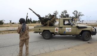 In this May 21, 2019 file photo, Tripoli government forces clash with forces led by Field Marshal Khalifa Hifter, south of the capital Tripoli, Libya. Two Libyan militia commanders and a Syrian war monitor group say Turkey is deploying Syrian extremists to fight in Libya&#x27;s civil war. These extremists are affiliated with groups like al-Qaida and the Islamic State. They&#x27;re fighting as mercenaries on behalf of the United Nations-supported government in Libya. The Libyan sources told The Associated Press that Turkey has airlifted more than 2,500 foreign fighters into Tripoli, and that dozens are extremist-affiliated. (AP Photo/Hazem Ahmed, File) **FILE**