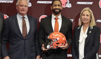 Cleveland Browns general manager Andrew Berry, center, poses for a photo with owners Jimmy Haslam, left, and Dee Haslam, right, after speaking during a news conference at the NFL football team&#39;s training facility, Wednesday, Feb. 5, 2020, in Berea, Ohio. Berry returned to the team after a one-year stint in the Philadelphia Eagles&#39; front office. Berry was the Browns&#39; vice president of player personnel from 2016-18. (AP Photo/Tony Dejak)