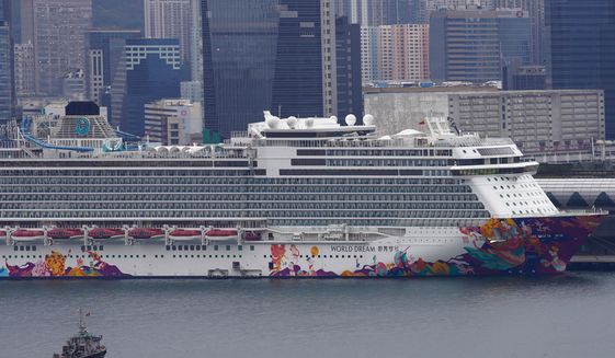 The World Dream cruise ship docked at Kai Tak cruise terminal in Hong Kong, Wednesday, Feb. 5, 2020. A Hong Kong official says more than 1,800 people on board the cruise ship that was turned away from a Taiwanese port will be quarantined until they are checked for a new virus. (AP Photo/Vincent Yu)