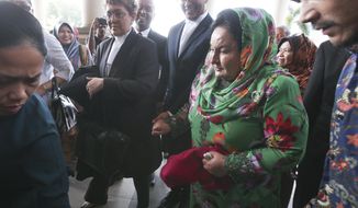 Rosmah Mansor, right, wife of former Malaysian Prime Minister Najib Razak, arrives at Kuala Lumpur High Court in Kuala Lumpur, Malaysia, Wednesday, Feb. 5, 2020. The graft trial of Rosmah has begun, with a top prosecutor saying she wielded considerable influence. (AP Photo)