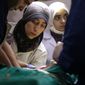 This image released by National Geographic shows Dr. Amani, center, in the operating room in Syria in a scene from the Oscar nominated documentary &amp;quot;The Cave.&amp;quot; (National Geographic via AP)