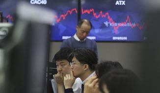 Currency traders watch monitors at the foreign exchange dealing room of the KEB Hana Bank headquarters in Seoul, South Korea, Wednesday, Feb. 5, 2020. Asian shares rose Wednesday on optimism that China&#39;s latest actions may help curtail some of the expected economic damage from the virus outbreak. (AP Photo/Ahn Young-joon)