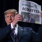 President Donald Trump holds up a newspaper with the headline that reads &quot;ACQUITTED&quot; at the 68th annual National Prayer Breakfast, at the Washington Hilton, Thursday, Feb. 6, 2020, in Washington. (AP Photo/ Evan Vucci)