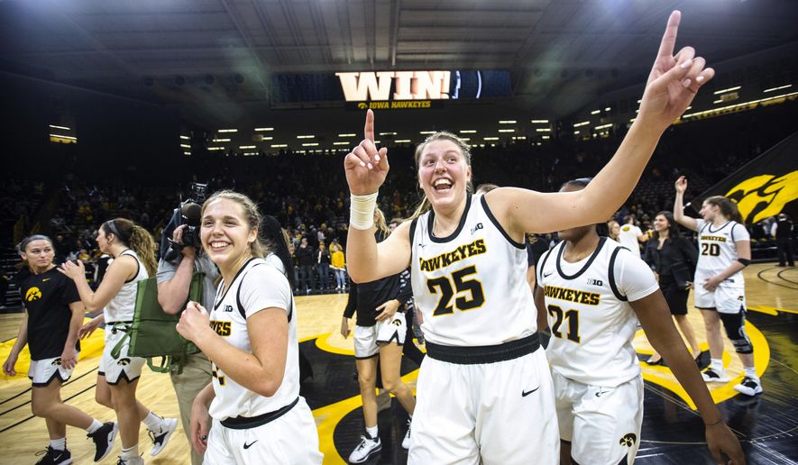 Iowa guard Kathleen Doyle, left, and center Monika Czinano (25) celebrate after the team's NCAA college basketball game againstNebraska, Thursday, Feb. 6, 2020, in Iowa City, Iowa. (Joseph Cress/Iowa City Press-Citizen via AP)
