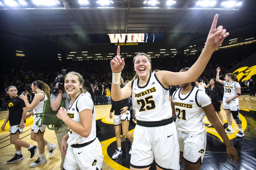 Iowa guard Kathleen Doyle, left, and center Monika Czinano (25) celebrate after the team's NCAA college basketball game againstNebraska, Thursday, Feb. 6, 2020, in Iowa City, Iowa. (Joseph Cress/Iowa City Press-Citizen via AP)
