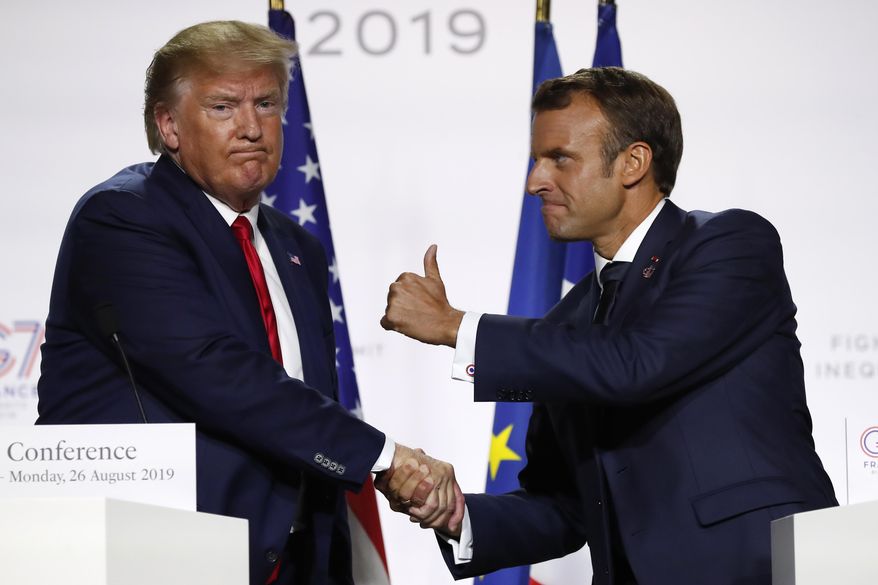 FILE - In this Aug. 26, 2019, file photo, French President Emmanuel Macron and U.S President Donald Trump shake hands during the final press conference during the G7 summit in Biarritz, southwestern France. Famously muscular white-knuckle handshakes between Trump and Macron have served as metaphors for a difficult and turbulent relationship. (AP Photo/Francois Mori, File)