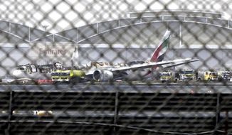 FILE - In this Aug 3, 2016 file photo, a damaged Boeing 777 is seen at the Dubai airport after it crash-landed, in Dubai, United Arab Emirates. An investigative report released Thursday, Feb. 6, 2020, found that the pilots of an Emirates flight that crashed in 2016 and caught fire in Dubai failed to realize the engines of their Boeing 777 remained idle as they tried to take off from a failed landing attempt. (AP Photo/Jon Gambrell, File)