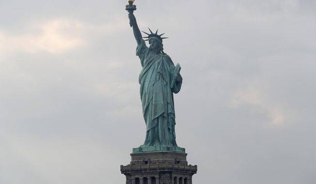 In this Aug. 14, 2019 file photo, The Statue of Liberty is shown in New York. The Department of Homeland Security says New York residents will be cut off from 鈥榯rusted traveler鈥� programs because of a state law that prevents immigration officials from accessing motor vehicle records. Acting Deputy DHS Secretary Ken Cuccinelli says tens of thousands of New Yorkers will be inconvenienced by the action.  (AP Photo/Kathy Willens)