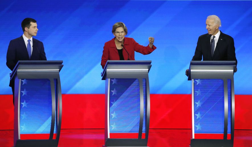 Democratic presidential candidate Sen. Elizabeth Warren, D-Mass., center, speaks as former South Bend, Ind., Mayor Pete Buttigieg, left, and former Vice President Joe Biden listen during a Democratic presidential primary debate, Friday, Feb. 7, 2020, hosted by ABC News, Apple News, and WMUR-TV at Saint Anselm College in Manchester, N.H. (AP Photo/Elise Amendola)