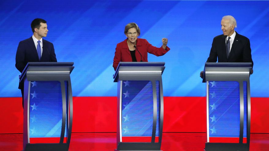 Democratic presidential candidate Sen. Elizabeth Warren, D-Mass., center, speaks as former South Bend, Ind., Mayor Pete Buttigieg, left, and former Vice President Joe Biden listen during a Democratic presidential primary debate, Friday, Feb. 7, 2020, hosted by ABC News, Apple News, and WMUR-TV at Saint Anselm College in Manchester, N.H. (AP Photo/Elise Amendola)