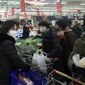 People wearing masks buy foods at a supermarket in Hangzhou in east China&#39;s Zhejiang province, Saturday, Feb. 8, 2020. China&#39;s communist leaders are striving to keep food flowing to crowded cities despite anti-disease controls, to quell fears of possible shortages and stave off price spikes from panic buying after most access to Wuhan was cut off Jan. 23. Food stocks in supermarkets ran low shortly after Beijing imposed travel curbs and extended the Lunar New Year holiday to keep factories, offices and other businesses closed and the public at home, attempting to prevent the virus from spreading. (Chinatopix via AP)