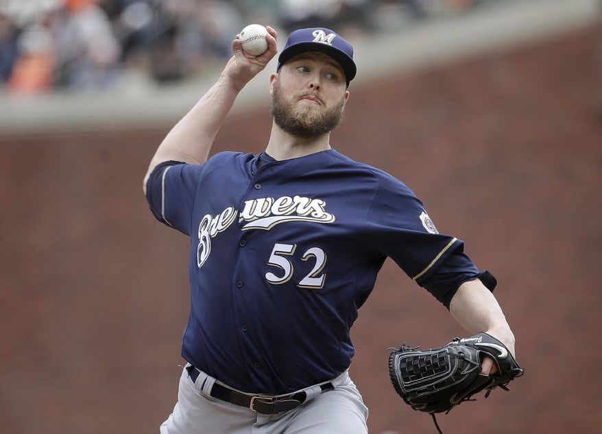 FILE - In this Saturday, June 15, 2019 file photo, Milwaukee Brewers pitcher Jimmy Nelson (52) throws to a San Francisco Giants batter during the second inning of a baseball game in San Francisco. Right-hander Jimmy Nelson and the Los Angeles Dodgers agreed Tuesday, Jan. 7, 2020 to a $1.25 million, one-year contract, an incentive-laden deal that could be worth $13.25 million over two seasons. In what's become a familiar refrain, the Dodgers arrive at camp still looking for their first World Series championship since 1988. After losing in two straight World Series, they were ousted by Washington in five games in the NL Division Series last fall. (AP Photo/Jeff Chiu, File)