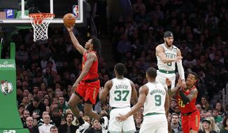 Atlanta Hawks guard Treveon Graham drives to the basket ahead of Boston Celtics defenders during the first half of an NBA basketball game, Friday, Feb. 7, 2020, in Boston. (AP Photo/Mary Schwalm)