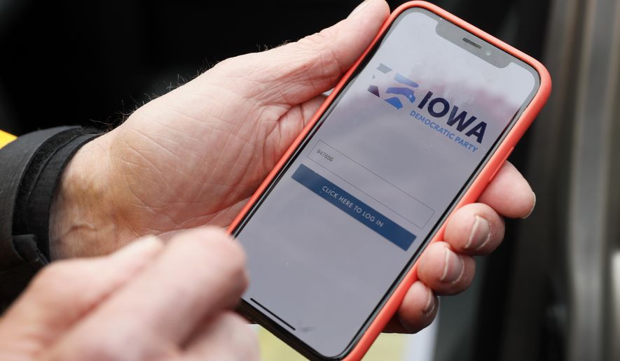 FILE - In this Friday, Nov. 15, 2019 file photo, a precinct captain from Des Moines, Iowa, holds his iPhone that shows the Iowa Democratic Party's caucus reporting app. On Friday, Feb. 7, 2020, The Associated Press reported on stories circulating online incorrectly asserting that federal records show George Soros is the biggest funder of the failed app used by the Iowa Democratic Party during Monday’s caucuses. The chart used in the assertion does not show a donation by Soros to Shadow Inc. Instead, the chart, which was published in a November 2019 story on the investigative news site Sludge, shows Soros gave $2.6 million to the National Democratic Redistricting Committee, a Democratic Party-aligned organization focused on legislative redistricting. (AP Photo/Charlie Neibergall)