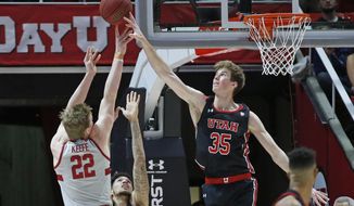 Utah center Branden Carlson (35) blocks a shot by Stanford forward James Keefe (22) during the second half of an NCAA college basketball game Thursday, Feb. 6, 2020, in Salt Lake City. (AP Photo/Rick Bowmer)