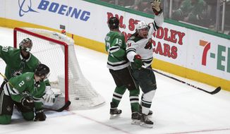 Minnesota Wild center Joel Eriksson Ek (14) celebrates after scoring the winning goal in the third period against the Dallas Stars during an NHL hockey game Friday, Feb. 7, 2020, in Dallas. (AP Photo/Richard W. Rodriguez)