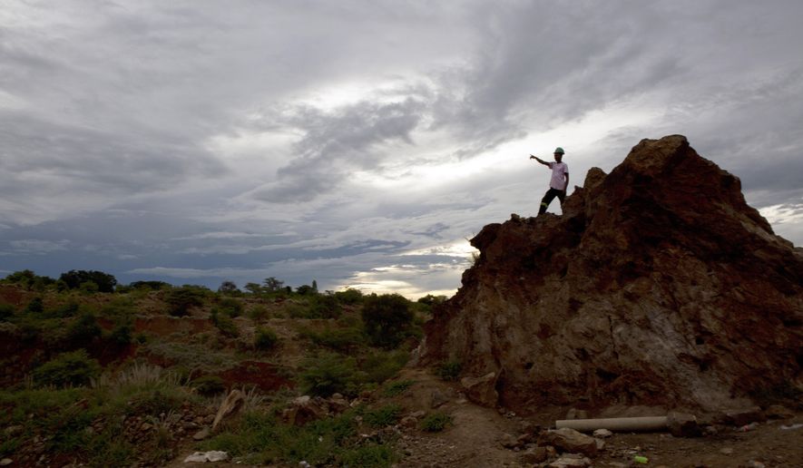 An artisanal miner is seen near the site where some miners were trapped underground following the collapse of a mine shaft in Kwekwe, Zimbabwe, Friday, Feb, 7, 2020. Zimbabwe's rescue agency says it has ended rescue operations at the mine where two people died after been trapped underground. Spokesman Paul Nyathi said the miners have been trapped since Wednesday when they entered for the night shift at the gold mine near Kwekwe city in central Zimbabwe. (AP Photo/Tsvangirayi Mukwazhi)