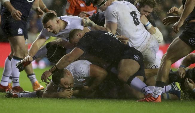 England&#x27;s Ellis Genge, bottom left, scores a try in Storm Ciara during the Six Nations rugby union international match between Scotland and England at Murrayfield Stadium, in Edinburgh, Scotland, Saturday, Feb. 8, 2020. (AP Photo/Scott Heppell)