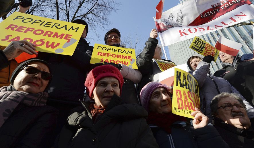 Supporters of Poland's right-wing government rally to show their support for legislation which gives the government greater control of judges, in Warsaw, Poland, Saturday, Feb. 8, 2020. Those gathered urged the government not to given in to the European Union, which has criticized recently passed legislation which gives the government the power to fire judges whose rulings authorities do not like. They called the judicial changes a matter of national sovereignty. On yellow banners we read "I support reform judicial".(AP Photo/Czarek Sokolowski)