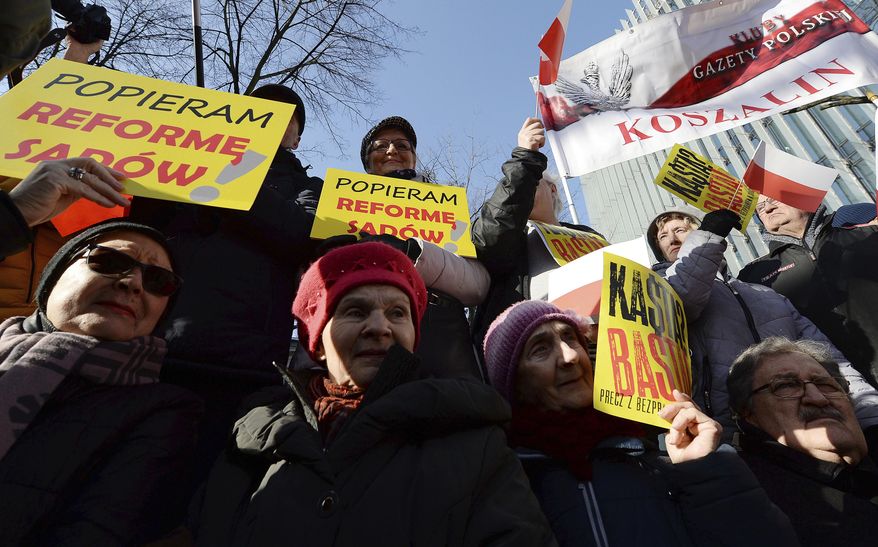 Supporters of Poland's right-wing government rally to show their support for legislation which gives the government greater control of judges, in Warsaw, Poland, Saturday, Feb. 8, 2020. Those gathered urged the government not to given in to the European Union, which has criticized recently passed legislation which gives the government the power to fire judges whose rulings authorities do not like. They called the judicial changes a matter of national sovereignty. On yellow banners we read "I support reform judicial".(AP Photo/Czarek Sokolowski)