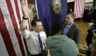 Democratic presidential candidate former South Bend, Ind., Mayor Pete Buttigieg, left, waves at the conclusion of a campaign rally, Sunday, Feb. 9, 2020, in Dover, N.H. (AP Photo/Steven Senne)
