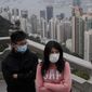 Tourists wear masks at the Peak, a popular tourist spot in Hong Kong, Sunday, Feb. 9, 2020. Health authorities are scrambling to halt the spread of a new virus that has killed hundreds in China, restricting visitors from the country and confining thousands on cruise ships for extensive screening after passengers have tested positive. (AP Photo/Kin Cheung)