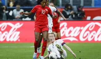 U.S. defender Emily Sonnett, right, kicks the ball away from Canada defender Ashley Lawrence during the first half of a CONCACAF women&#39;s Olympic qualifying soccer match Sunday, Feb. 9, 2020, in Carson, Calif. (AP Photo/Chris Carlson)