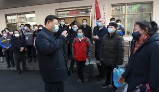In this photo released by Xinhua News Agency, Chinese President Xi Jinping wearing a protective face mask speaks to residents as he inspects the novel coronavirus pneumonia prevention and control work at a neighbourhoods in Beijing, Monday, Feb. 10, 2020. China reported a rise in new virus cases on Monday, possibly denting optimism that its disease control measures like isolating major cities might be working, while Japan reported dozens of new cases aboard a quarantined cruise ship. (Pang Xinglei/Xinhua via AP)