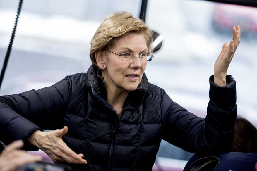 Democratic presidential candidate Sen. Elizabeth Warren, D-Mass., speaks to members of the media on a media bus outside at a campaign stop at Rochester Opera House, Monday, Feb. 10, 2020, in Rochester, N.H. (AP Photo/Andrew Harnik)