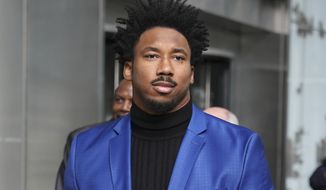 FILE - In this Nov. 20, 2019, file photo, Cleveland Browns star defensive end Myles Garrett leaves an office building in New York. Suspended Browns star defensive end Myles Garrett met Monday, Feb. 10, 2020, with NFL Commissioner Roger Goodell to discuss his possible reinstatement, a person familiar with the meeting told The Associated Press. (AP Photo/Seth Wenig, File)
