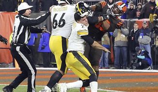FILE - In this Nov. 14, 2019, file photo, Cleveland Browns defensive end Myles Garrett (95) hits Pittsburgh Steelers quarterback Mason Rudolph (2) with a helmet during the second half of an NFL football game in Cleveland. Suspended Browns star defensive end Myles Garrett met Monday, Feb. 10, 2020, with NFL Commissioner Roger Goodell to discuss his possible reinstatement, a person familiar with the meeting told The Associated Press. (Joshua Gunter/Cleveland.com via AP, File)