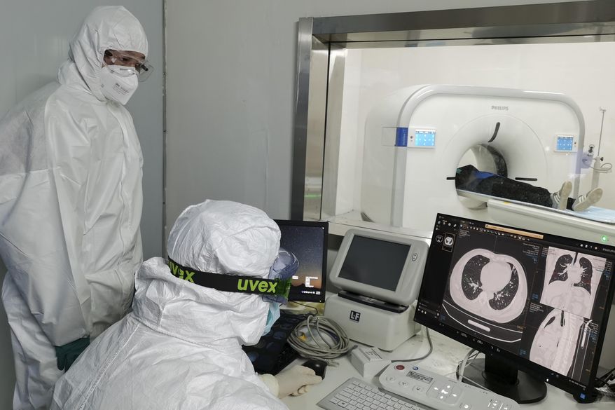 In this Sunday, Feb. 9, 2020, photo released by Xinhua News Agency, doctors scan a patient&#x27;s lungs at Huoshenshan temporary hospital built for patients diagnosed with coronavirus in Wuhan in central China&#x27;s Hubei province. Mainland China has reported another rise in cases of the new virus after a sharp decline the previous day, while the number of deaths grow over 900, with at least two more outside the country. (Gao Xiang/Xinhua via AP)