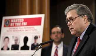 Attorney General William Barr speaks during a news conference, Monday, Feb. 10, 2020, at the Justice Department in Washington, as Principal Associate Deputy Attorney General Seth Ducharm looks on.  Four members of the Chinese military have been charged with breaking into the networks of the Equifax credit reporting agency and stealing the personal information of tens of millions of Americans, the Justice Department said Monday, blaming Beijing for one of the largest hacks in history. (AP Photo/Jacquelyn Martin)