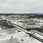 FILE - In this Nov. 28, 2018, file photo, snow covers the perimeter of the General Motors&#39; Lordstown plant, in Lordstown, Ohio. The Trump administration’s budget proposal scraps a loan program that could help an upstart electric vehicle company’s plans to reuse the now-closed General Motors factory in Lordstown, Ohio. (AP Photo/John Minchillo, File)