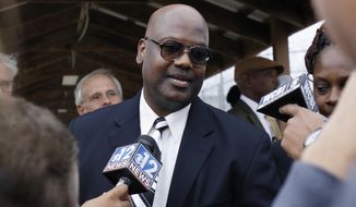 FILE - In this Monday, Dec. 16, 2019 file photo, Curtis Flowers speaks with reporters as he exits the Winston-Choctaw Regional Correctional Facility in Louisville, Miss. Mississippi&#39;s new attorney general must decide whether to take a quadruple murder case to a seventh trial. Curtis Flowers has had two mistrials and four reversed convictions in connection with the 1996 slayings of four people at a furniture store. (AP Photo/Rogelio V. Solis, File)